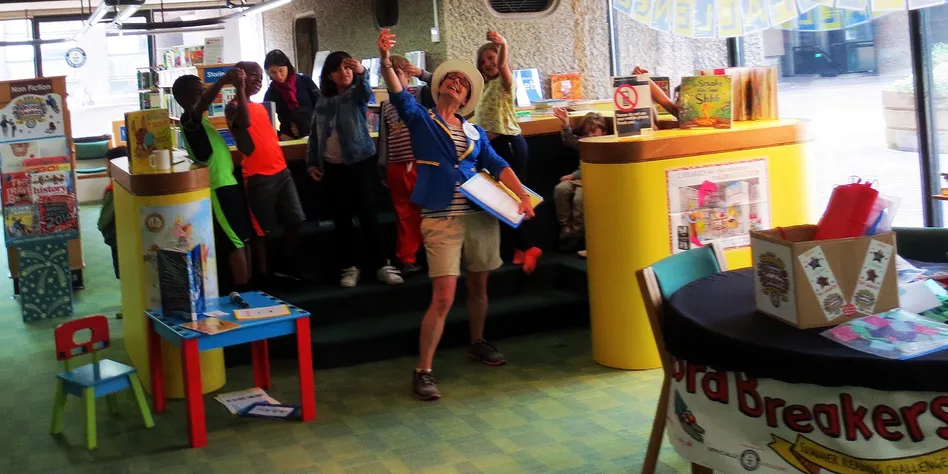 Vickie Holden storytelling at a library.